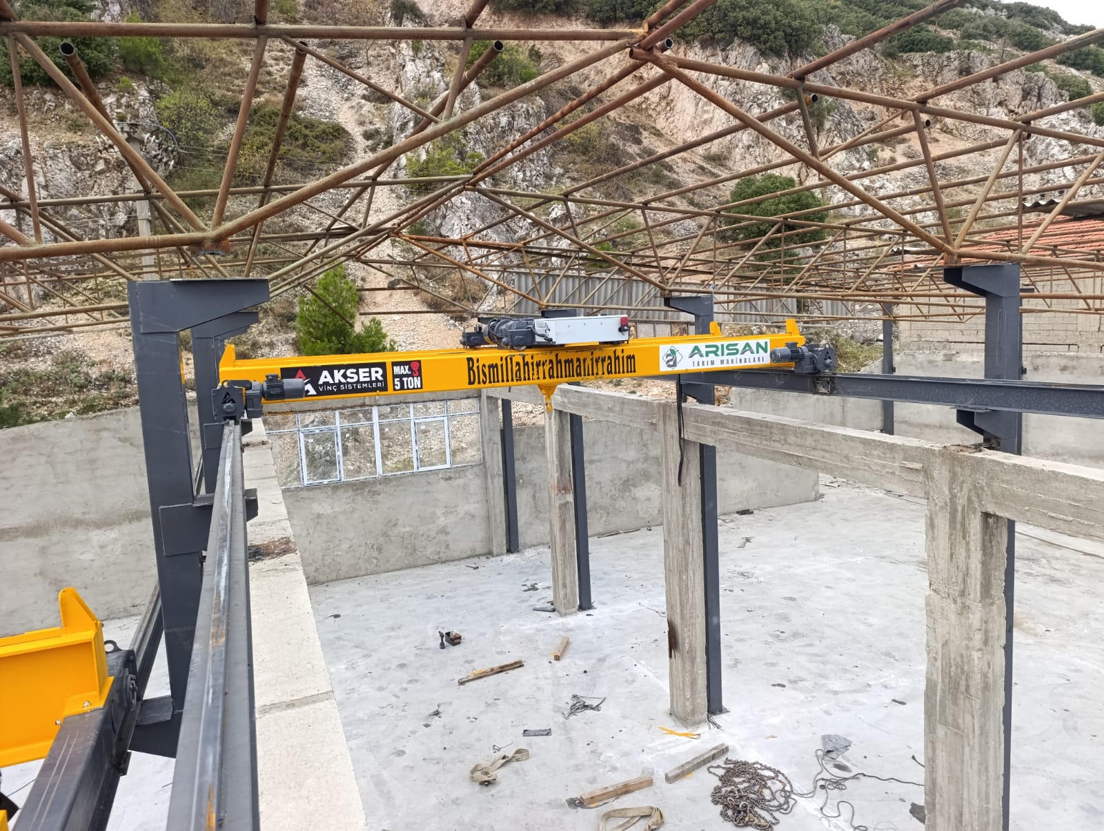 Endüstriyel yapıya monte edilen sarı AKSER vinç sistemi